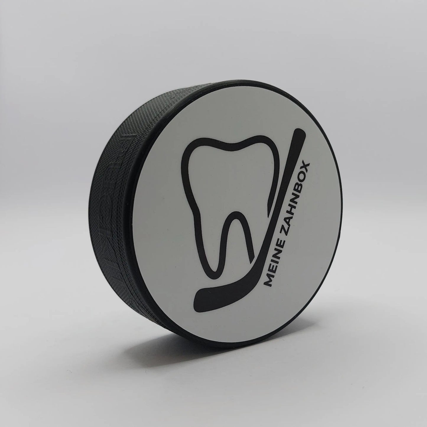 Zahndose im Eishockey Puck Design mit Zahn und Schläger Symbol – Vorderansicht